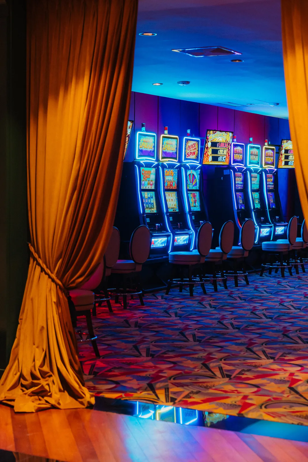 Gaming floor at Casino Dominic Golden curtains opening to the gaming floor of Casino Dominic