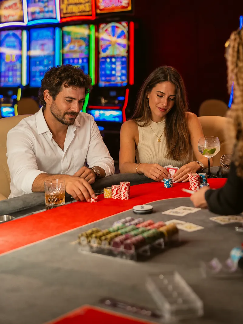 Poker – Casino Dominic, Punta Cana Couple at the poker table with cards and chips at Casino Dominic